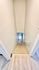 Inviting stairway with carpeted steps leading to a convenient laundry area, featuring a modern washer and dryer set.