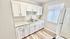 Bright and modern kitchen with sleek white cabinets, spacious countertops, and ample natural light.