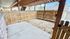 Charming fenced patio area with covered wooden ceiling, perfect for outdoor relaxation and privacy.