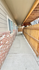 Charming exterior walkway with brick and woodwork, offering a welcoming entrance to your new home.