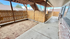 Charming outdoor patio space with wooden fencing, shaded coverage, and a cozy walkway.