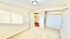 Bright and spacious bedroom with plush carpeting and a walk-in closet, showcasing a tranquil and modern living space.