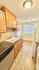 Bright kitchen with elegant wood cabinets, granite countertops, and modern appliances offering a cozy and functional cooking space.