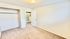 Bright room with plush carpet, spacious closet, and built-in shelving, perfect for creating a cozy bedroom retreat.