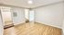 Bright and spacious room with modern wood flooring, fresh neutral paint, and an adjoining walk-in closet and bathroom.
