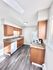 Bright and cozy kitchen with modern appliances, sleek countertops, and ample cabinet space.