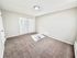 Bright and spacious bedroom with fresh carpet and ample closet space, perfect for modern living.