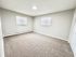 Bright and airy bedroom with plush carpet, neutral tones, and natural light showcasing spacious comfort.