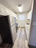 Bright, modern kitchen with sleek stainless steel appliances, white cabinetry, and stylish wood flooring.