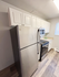 Modern kitchen featuring sleek stainless steel appliances and elegant white cabinetry, creating a bright and inviting cooking space.