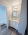 Modern bathroom featuring elegant lighting, a sleek vanity with a large mirror, and a bright, inviting atmosphere.