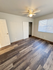Bright and airy bedroom with modern hardwood floors, spacious closet, and ceiling fan.
