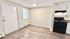 Modern apartment showcasing elegant flooring, bright open space, and a sleek kitchen area.