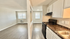 Bright and spacious open-plan apartment with modern kitchen and sunlit living area, perfect for comfortable urban living.
