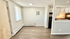 Bright apartment corner featuring an open kitchen with modern appliances and a cozy dining space.