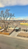 Charming suburban neighborhood view with cozy houses, mature trees, and a bright sky, perfect for tranquil living.