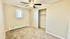 Bright, spacious bedroom with soft carpet, a ceiling fan, and a large closet, ideal for comfort and relaxation.