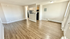 Bright open-concept living space with elegant wood flooring, cozy dining area, and modern kitchen appliances.