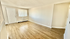 Bright and inviting living room with modern hardwood floors and ample natural light through large window.