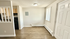 Bright and cozy entryway with modern flooring, featuring a semi-open kitchen design and ample natural light.
