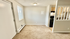 Charming apartment interior showcasing a cozy carpeted room with bright natural light, adjacent open kitchen, and stylish modern finishes.