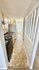 Charming kitchen with modern appliances, sleek countertops, and a bright, hallway view.