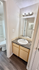 Modern bathroom vanity with sleek granite countertop and contemporary lighting.