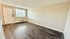 Inviting living area showcasing modern hardwood floors, natural light, and a cozy atmosphere.