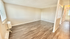 Bright, open living space with modern wood flooring and ample natural light streaming through large windows.