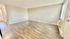 Inviting open-concept living area with natural light, featuring elegant wood flooring and a neutral color palette.