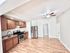 Charming apartment kitchen with modern stainless steel appliances, sleek wooden cabinets, and elegant hardwood flooring.