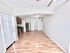 Bright and modern apartment interior with an open-concept kitchen and elegant wooden flooring.