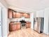 Modern kitchen with sleek stainless steel appliances, stylish wooden cabinets, and elegant polished floors.