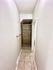 Inviting hallway leading to a stylish walk-in shower with elegant tile design.