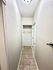 Contemporary hallway featuring elegant lighting and tiled flooring with built-in storage.