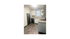 Contemporary kitchen design with sleek black appliances, white cabinetry, and modern dark wood flooring.
