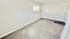Bright, spacious carpeted room with a large window letting in natural light, perfect for customization and comfort.