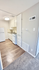 Modern compact kitchen with sleek cabinetry, energy-efficient appliances, and stylish wood flooring.