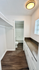 Bright and inviting walk-through closet with ample storage space leading into a modern bathroom with elegant fixtures.