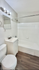Bright modern bathroom featuring sleek fixtures, a pristine bathtub-shower combo, and elegant lighting.