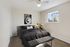 Bright bedroom with cozy double bed, stylish decor, and large window allowing natural light.