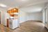 Bright and airy open-plan kitchen and living area with modern appliances and sleek wooden flooring.