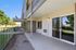 Charming patio view with sliding glass doors and lush green surroundings, perfect for relaxation and outdoor enjoyment.