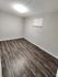 Cozy room with elegant wood flooring and bright modern lighting, perfect for a peaceful retreat.