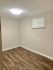 Inviting room with warm wood flooring and soft lighting, ideal for creating a cozy living space.