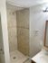 Modern bathroom with elegant tiled walk-in shower and chic vanity.