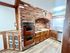 Charming kitchen with vintage double ovens, brick accents, and custom wood cabinetry, creating a cozy and rustic atmosphere.