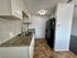 Modern kitchen with elegant tile backsplash, granite countertops, and sleek appliances offering a stylish cooking space.