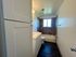 Bright and modern bathroom featuring sleek storage cabinets, a well-lit vanity, and a stylish bathtub with tiled walls, perfect for relaxation.