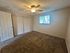 Bright and inviting bedroom with plush carpeting and ample closet space, perfect for relaxing and unwinding.